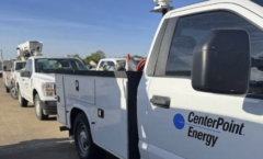 A white Ford utility truck with the words Cneter Point Energy is lined up with others in hte background