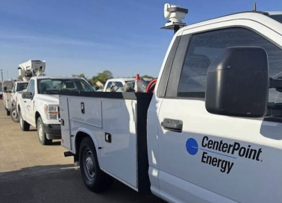 A white Ford utility truck with the words Cneter Point Energy is lined up with others in hte background